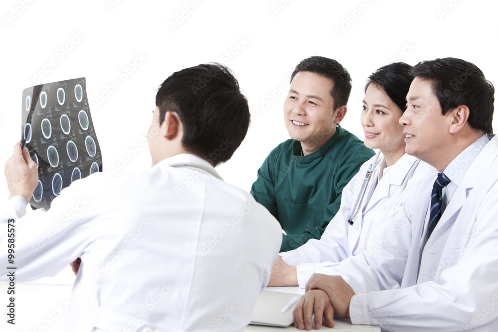 Professional medical team examining X-ray plate Professional medical team examining X-ray plate