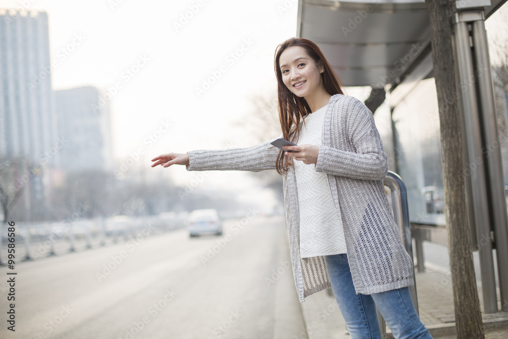 Young woman waiting for a taxi