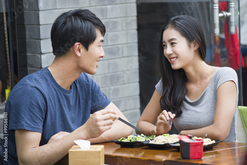 Happy young couple having lunch