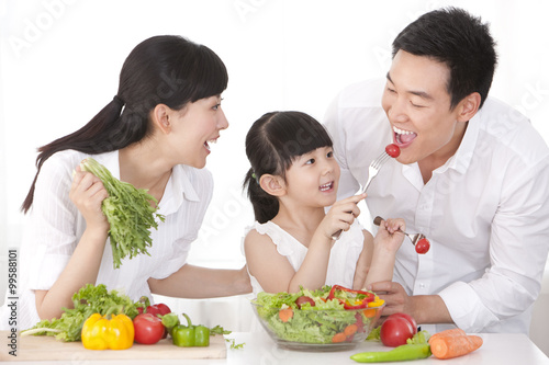 Family preparing a salad
