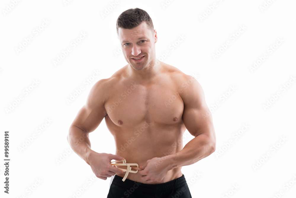 Muscular Man Measuring Fats With Caliper