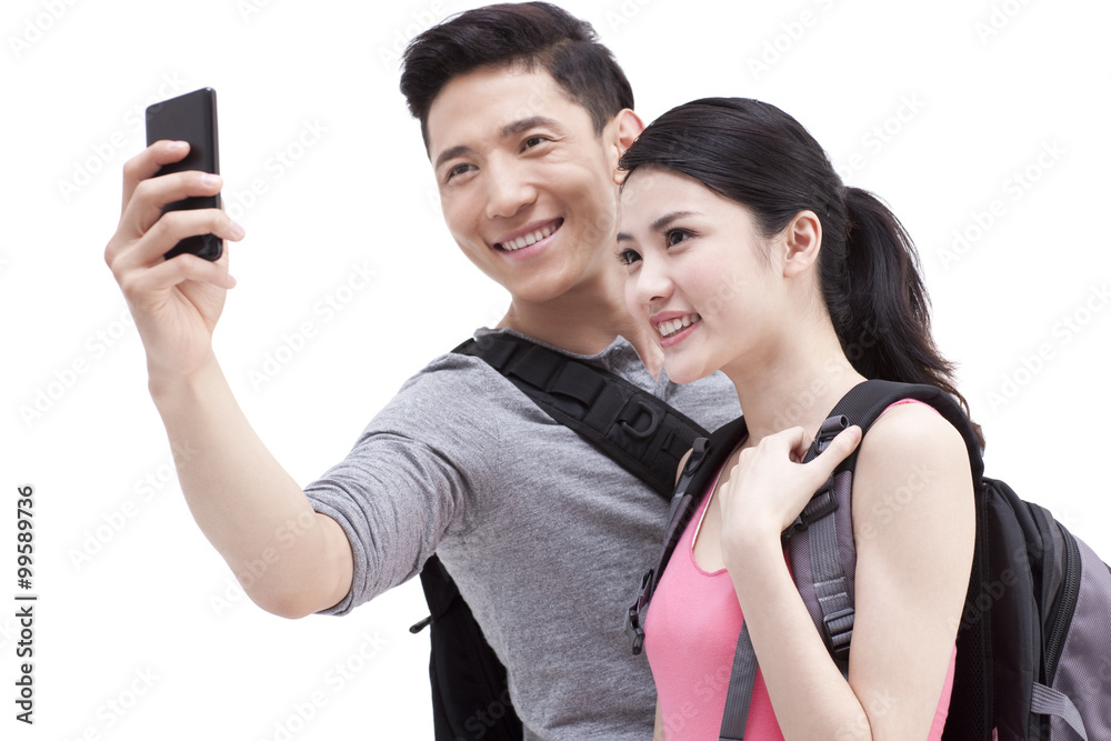 Cheerful college student photographing with smart phone Cheerful college student photographing with smart phone