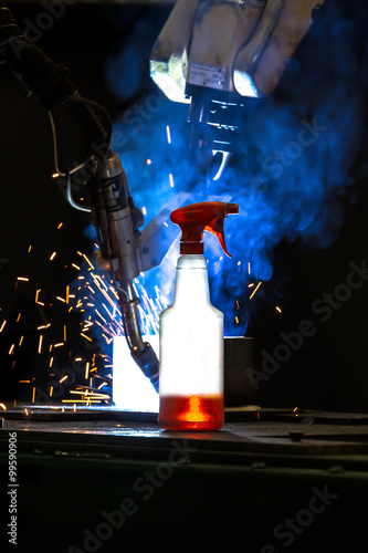 Plastic bottle with cleaning liquid glowing in front CNC Mig wel