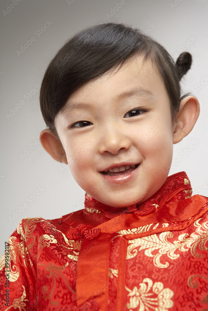 Portrait of young girl in festival Chinese New Year clothing, smiling at camera Portrait of young girl in festival Chinese New Year clothing, smiling at camera
