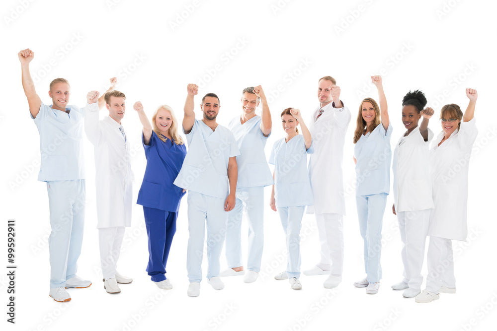 Multiethnic Medical Team Standing With Arms Raised Multiethnic Medical Team Standing With Arms Raised