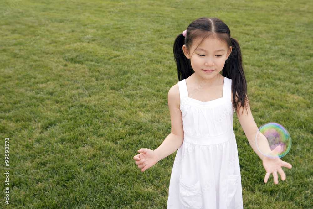 Young Girl Chasing Bubbles In Park Young Girl Chasing Bubbles In Park