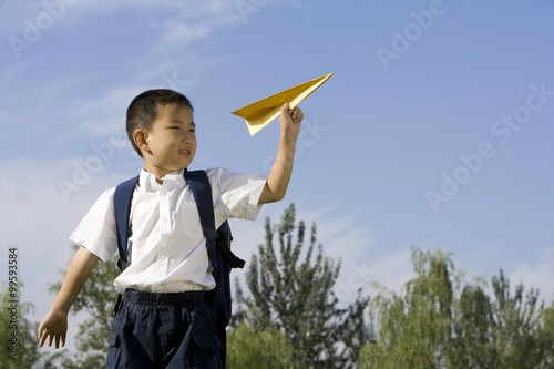 Boy playing with a paper airplane © Blue Jean Images