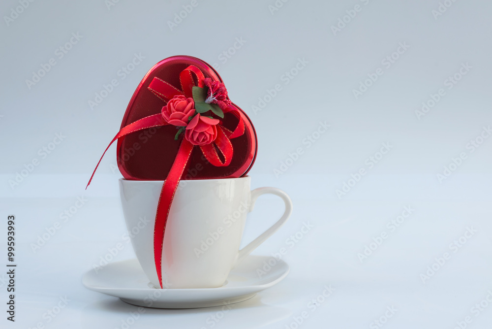 Valentine composition with hearts in a cup on white background Valentine composition with hearts in a cup on white background