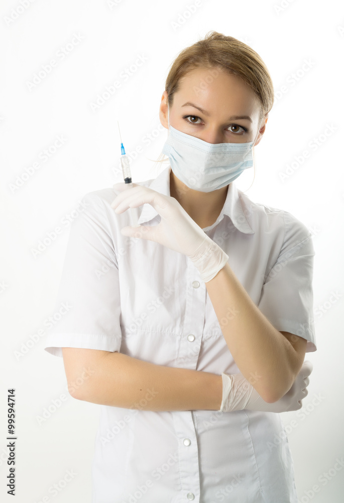 young girl in doctor bathrobe and rubber gloves holding a syringe young girl in doctor bathrobe and rubber gloves holding a syringe