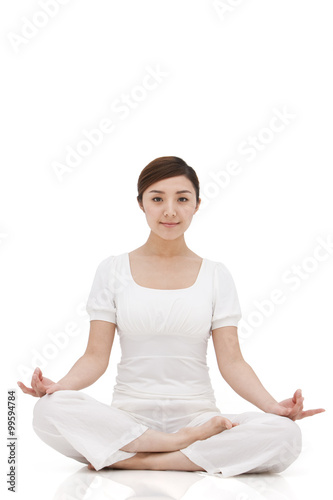 Young woman sitting and meditating © Blue Jean Images