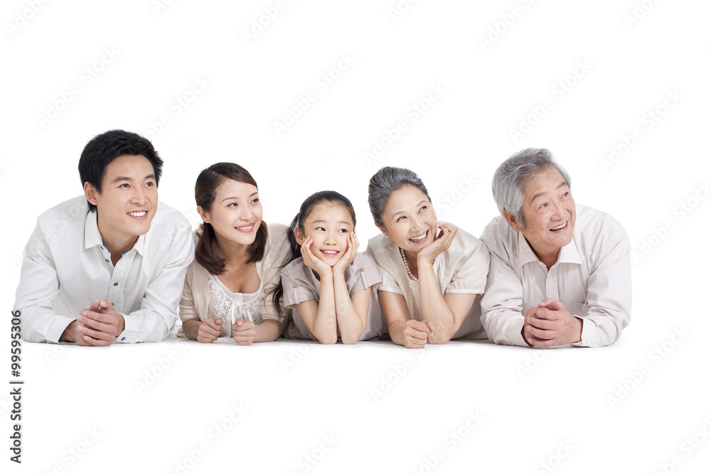 Happy family lying on front, studio shot Happy family lying on front, studio shot
