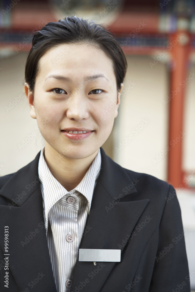 Young Woman Wearing A Name Badge Smiling At The Camera Young Woman Wearing A Name Badge Smiling At The Camera