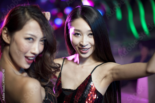 Stylish young women dancing in nightclub