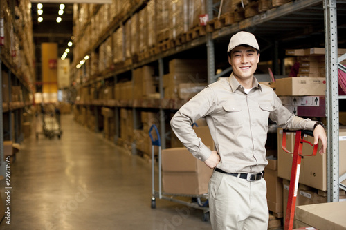 Male Chinese warehouse worker with a pushcart