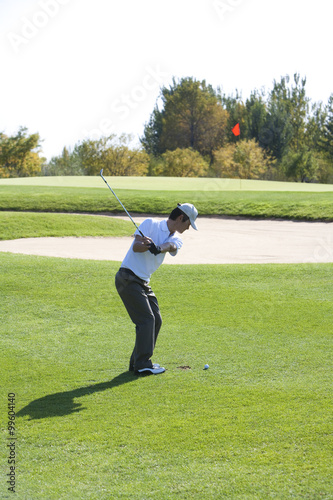 Young Man Taking a Golf Swing © Blue Jean Images