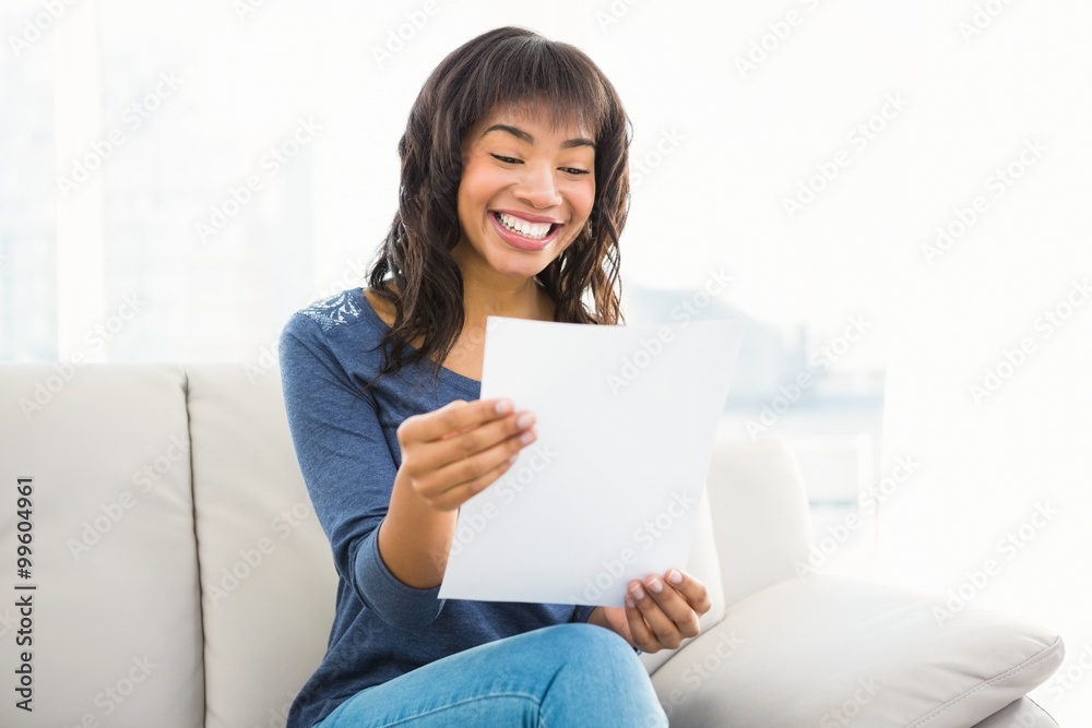 Casual smiling woman reading paper Casual smiling woman reading paper