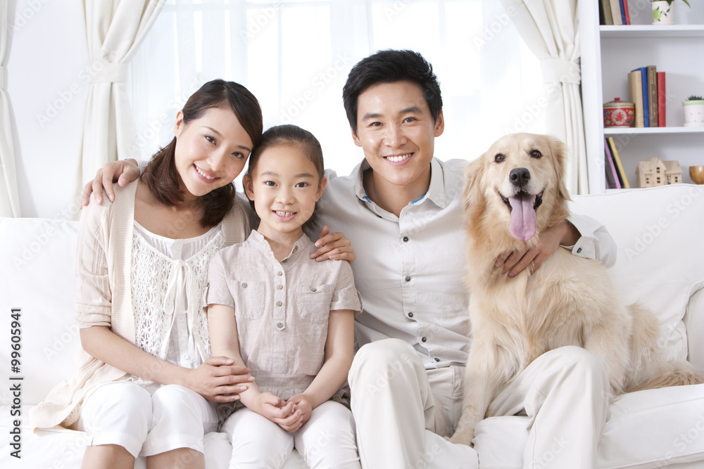 Happy family and dog on sofa