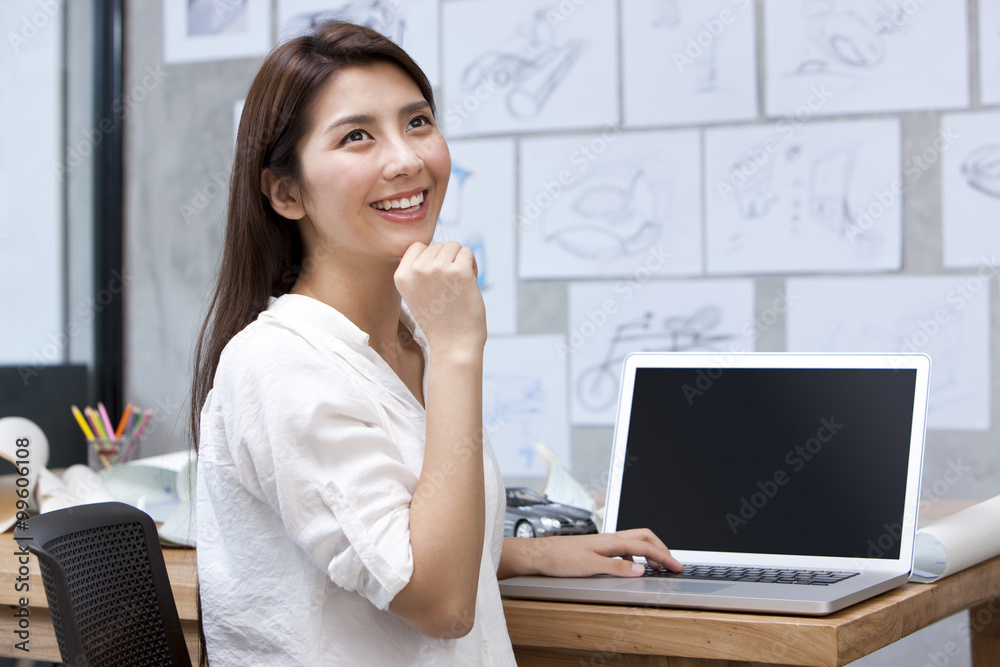 Female designer using laptop in studio Female designer using laptop in studio