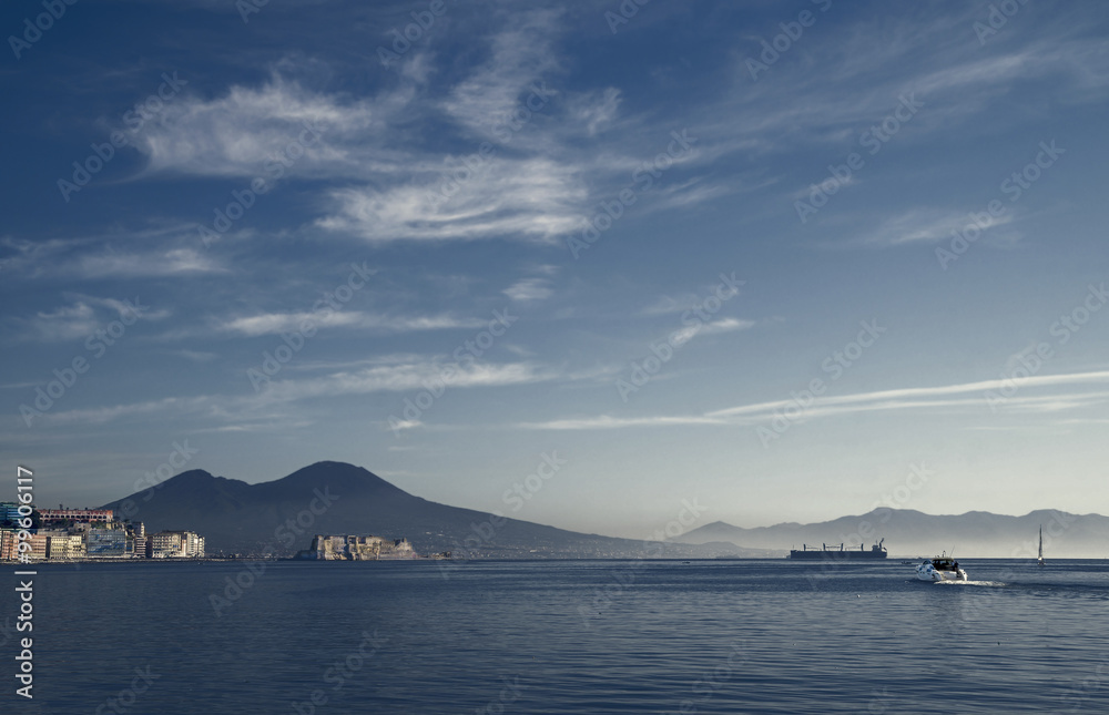 Evening over bay of Naples, famous port at the Mediterranean sea. At the background is Castel dell'Ovo and Vesuvius Volcano. Evening over bay of Naples, famous port at the Mediterranean sea. At the background is Castel dell'Ovo and Vesuvius Volcano.