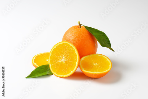 Fresh ripe oranges with leaves