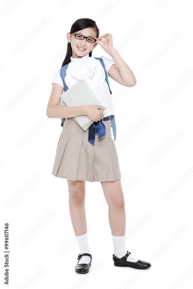 Pretty schoolgirl adjusting her glasses with books and schoolbag Pretty schoolgirl adjusting her glasses with books and schoolbag