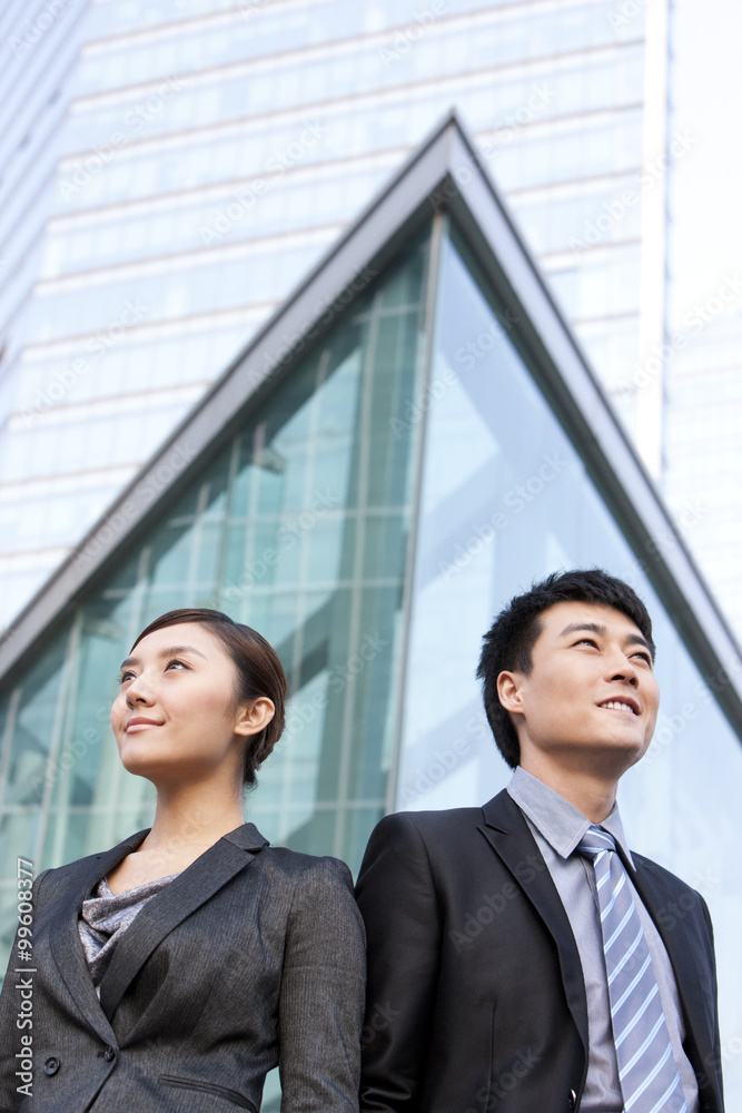 Businessman and businesswoman by building exterior