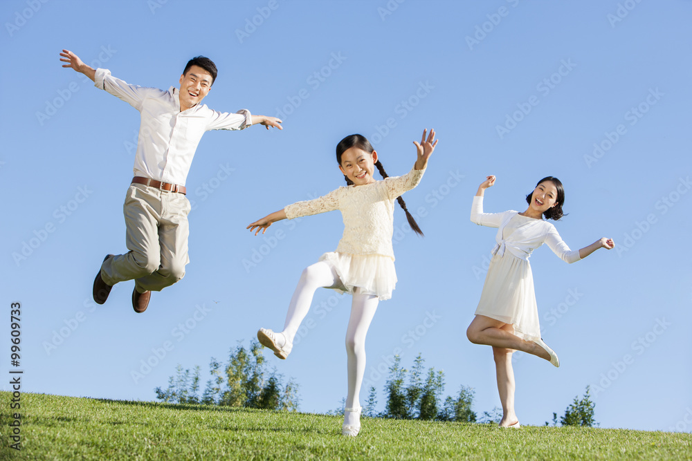 Cheerful young family having fun in a park Cheerful young family having fun in a park