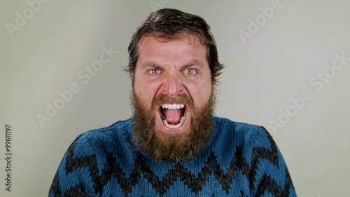 Hipster man screaming in studio on neutral background