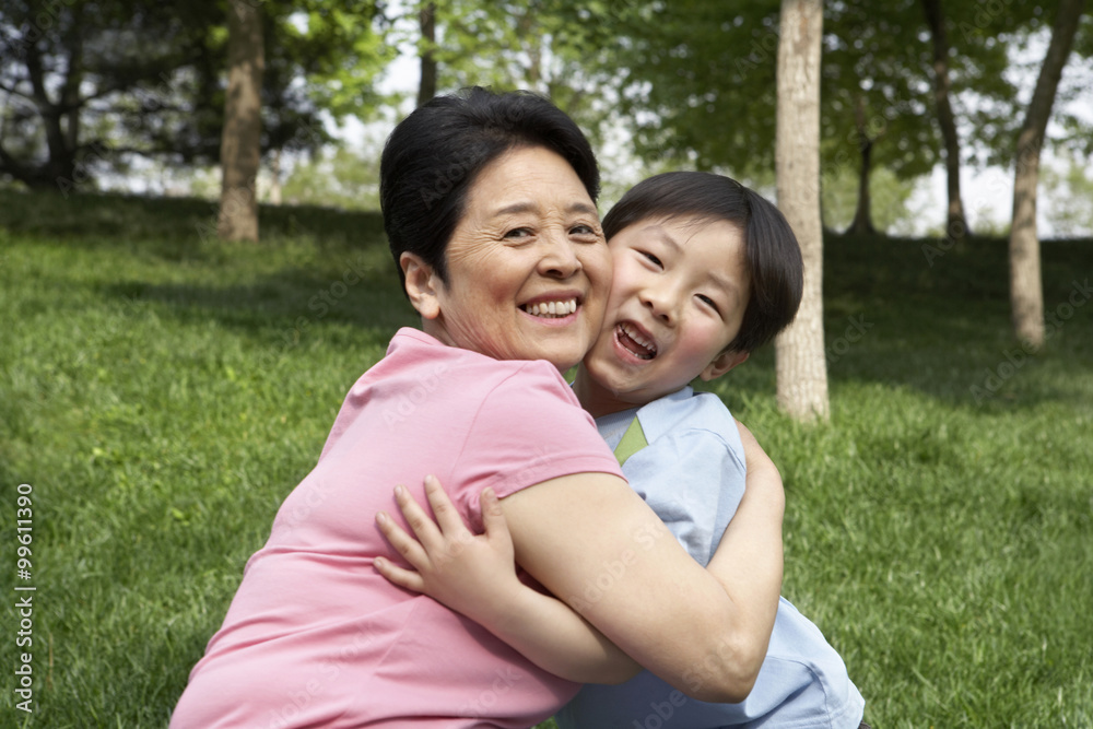 Portrait Of A Grandmother And Grandson Hugging In The Park Portrait Of A Grandmother And Grandson Hugging In The Park