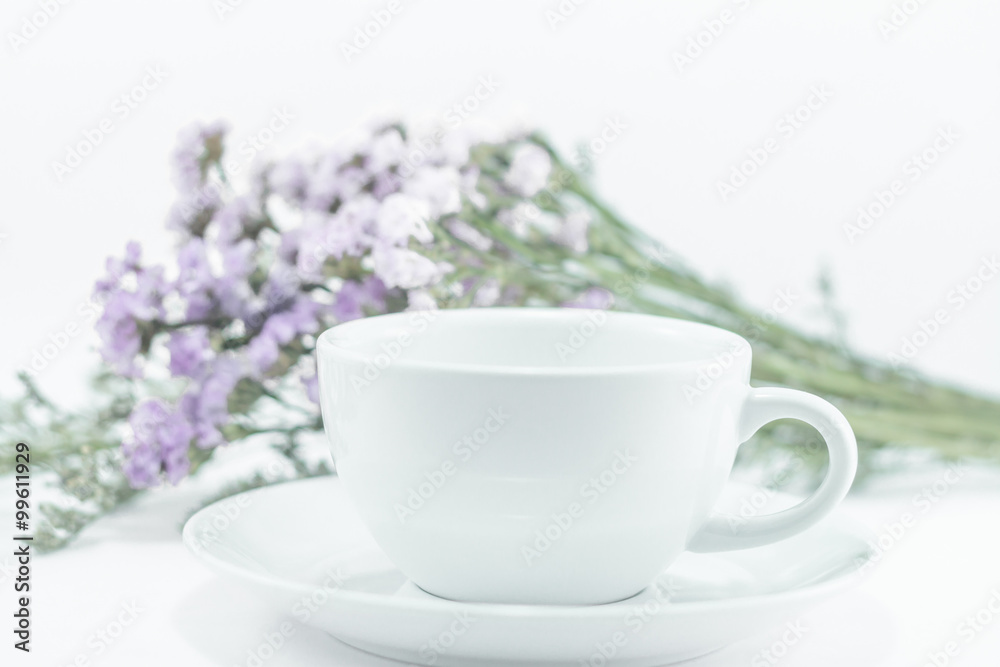 White mug cup and static flower