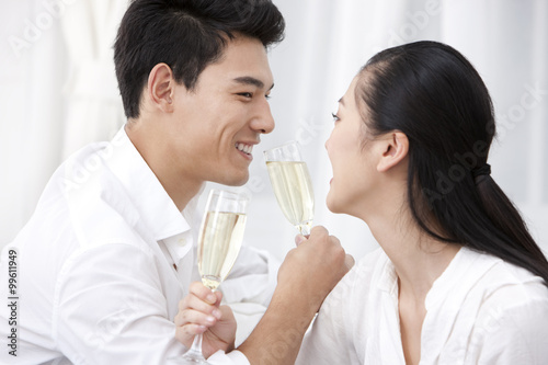 Happy young couple drinking champagne