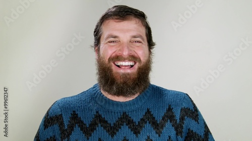 Hipster man laughing out loud on neutral background