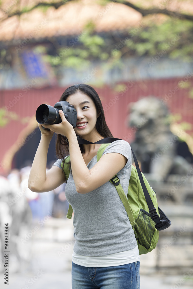 Young woman taking pictures in the Lama Temple