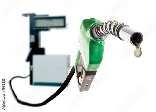 Obraz na plátně Green gas nozzle with one last drop of fuel and the station on white background