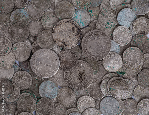 trove of ancient medieval coins silver background photo