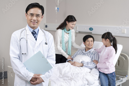 Portrait of a doctor with his patient and his patient s family