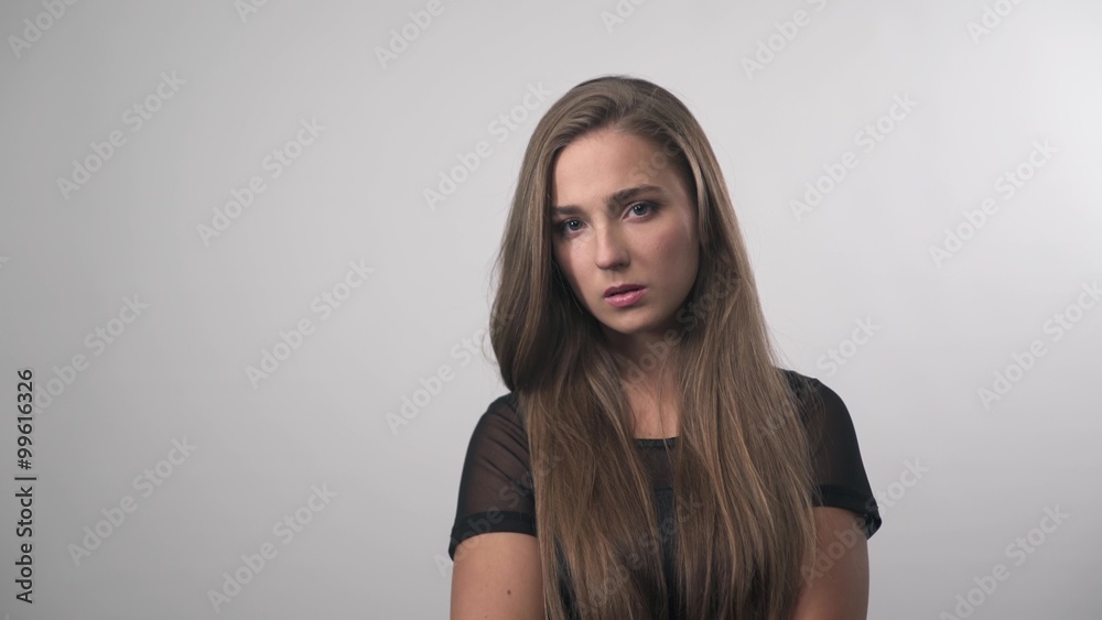 Portrait of sad depressed girl thinking about something.Pretty woman posing for the camera on white background Portrait of sad depressed girl thinking about something.Pretty woman posing for the camera on white background