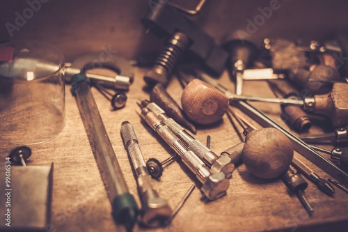 Different goldsmiths tools on the goldsmith workplace. photo