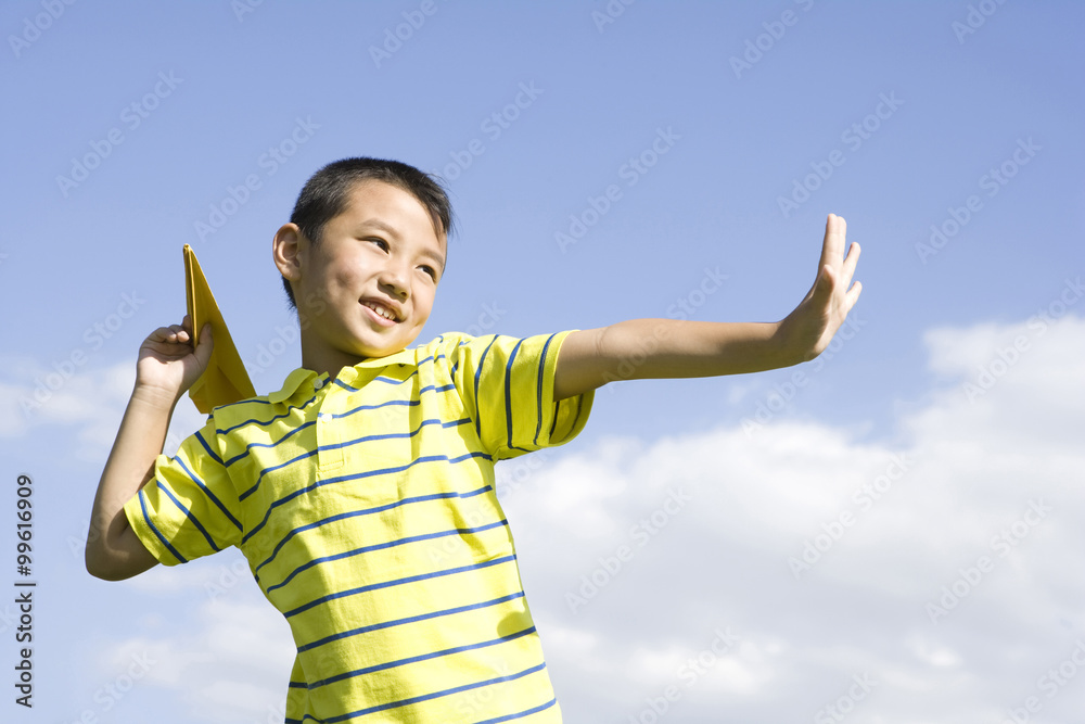 Boy playing with a paper airplane Boy playing with a paper airplane