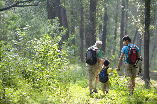 Boy hiking with his father and grandfather