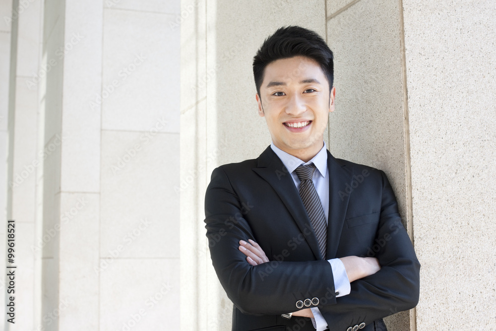 Professional businessman arms crossed in CBD Professional businessman arms crossed in CBD