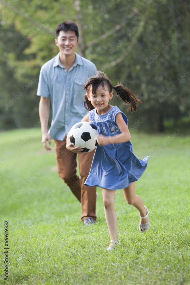Obraz premium Happy father and daughter playing football