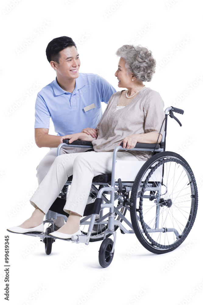 Male nursing assistant taking care of senior in wheelchair Male nursing assistant taking care of senior in wheelchair