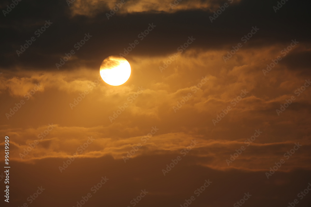 Brilliant orange sunrise over clouds.