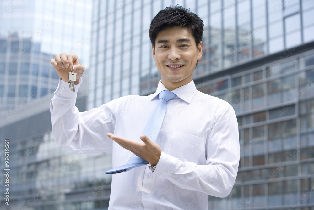 Businessman holding keys Businessman holding keys