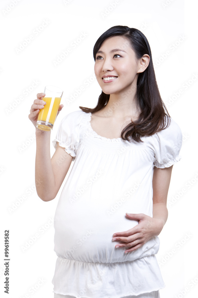Pregnant young woman and orange juice Pregnant young woman and orange juice