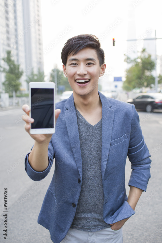 Confident young man showing smart phone