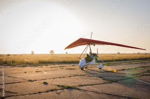 Hang-gliding, standing at dawn on the runway photo