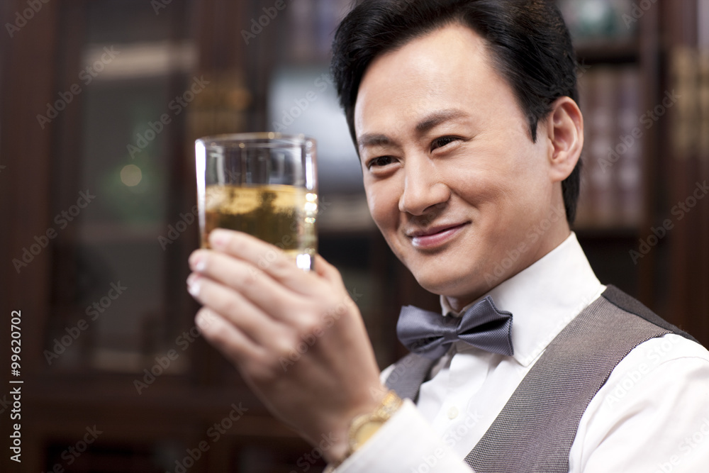 Businessman appreciating fine wine Businessman appreciating fine wine