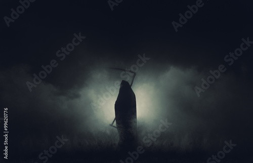 Fotografia Grim reaper, the death itself, scary horror shot of Grim Reaper in fog holding scythe